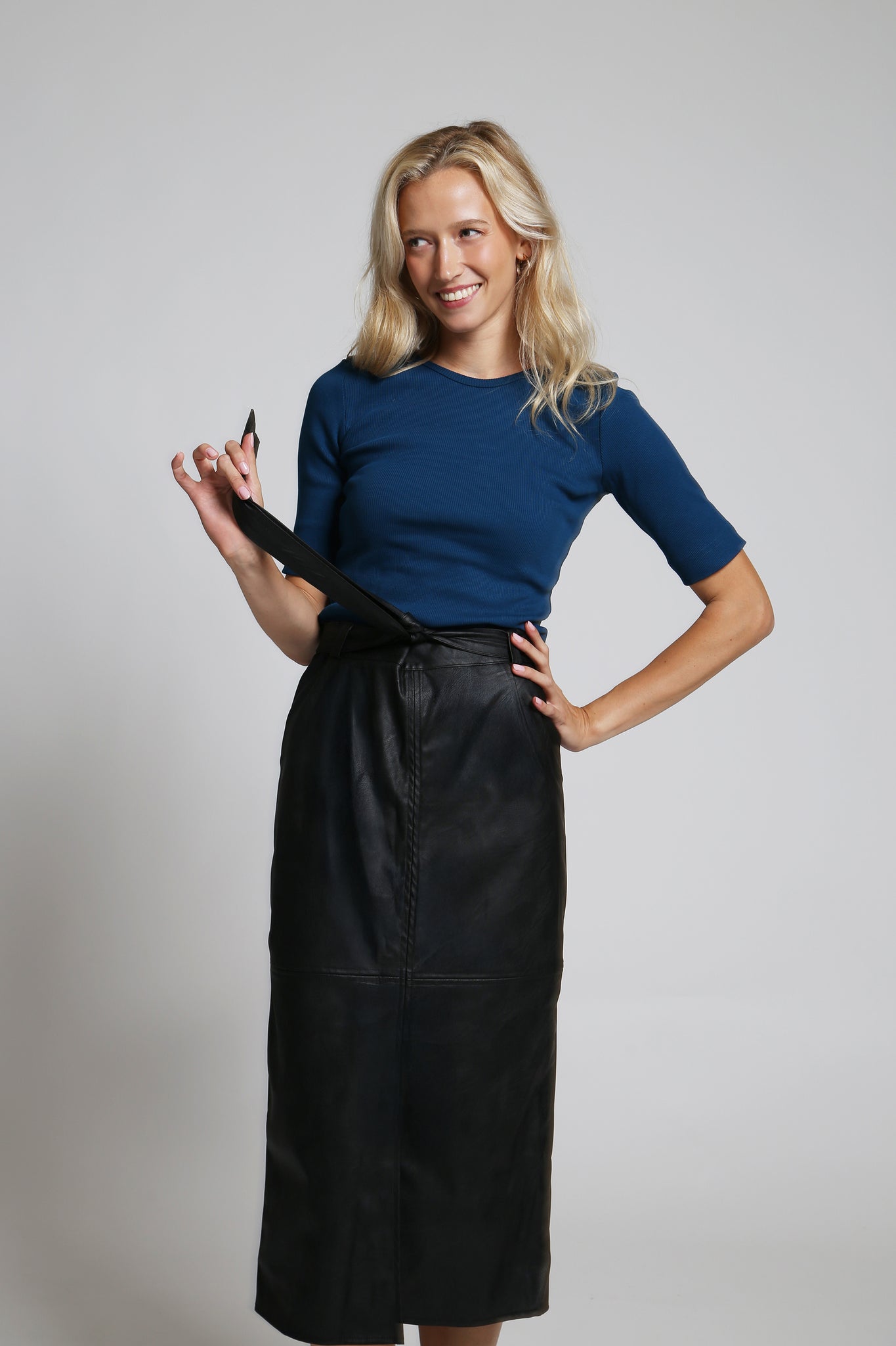 NOVINKA - Midi sukně z eko kůže s páskem a rozparkem – černá